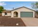 Charming single-story home featuring an arched entryway, a two-car garage, and desert landscaping at 2006 N Arrowhead Dr, Chandler, AZ 85224