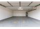 Spacious garage with concrete floors, white walls, overhead storage racks, and water heater at 2006 N Arrowhead Dr, Chandler, AZ 85224