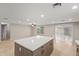 Spacious kitchen featuring a large island and sliding glass door leading outside at 2006 N Arrowhead Dr, Chandler, AZ 85224