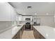 Bright kitchen featuring an island, stainless steel appliances, and modern fixtures at 2006 N Arrowhead Dr, Chandler, AZ 85224