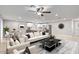 Bright, open-concept living room and kitchen area with sleek modern furniture and stainless steel appliances at 2006 N Arrowhead Dr, Chandler, AZ 85224
