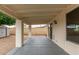 Covered patio with brick columns, concrete floor, sliding glass doors, and exterior lighting at 2006 N Arrowhead Dr, Chandler, AZ 85224