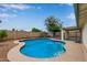 Backyard with a large in-ground swimming pool surrounded by concrete, a shed, and fencing at 2006 N Arrowhead Dr, Chandler, AZ 85224