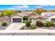 An aerial view showcasing the home's roof, spacious driveway, lush landscaping, and surroundings at 20642 N 268Th Dr, Buckeye, AZ 85396