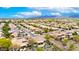Scenic aerial view showcasing a residential community, desert landscaping, tile roofs, and mountain views under a bright sky at 20642 N 268Th Dr, Buckeye, AZ 85396