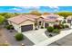 Aerial view of a well-maintained home with a tile roof, desert landscaping, and an attached garage at 20642 N 268Th Dr, Buckeye, AZ 85396