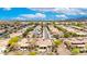 Expansive aerial view of a residential neighborhood with solar panels, desert landscaping, and scenic mountain backdrop at 20642 N 268Th Dr, Buckeye, AZ 85396