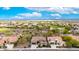 High aerial view of a community featuring green spaces, desert landscaping, and multiple single-Gathering homes at 20642 N 268Th Dr, Buckeye, AZ 85396