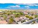 Aerial view of homes with tile roofs and solar panels throughout a community with desert landscaping at 20642 N 268Th Dr, Buckeye, AZ 85396