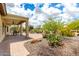 Well-manicured backyard with desert landscaping, covered patio, and pavers at 20642 N 268Th Dr, Buckeye, AZ 85396