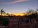 Picturesque desert backyard view at sunset with desert landscaping and beautiful sky at 20642 N 268Th Dr, Buckeye, AZ 85396