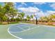 Outdoor basketball court area with benches and mature trees under a beautiful blue sky at 20642 N 268Th Dr, Buckeye, AZ 85396