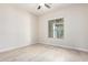 Bright bedroom with a ceiling fan, wood-look floors, and a large window at 20642 N 268Th Dr, Buckeye, AZ 85396