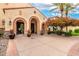 The clubhouse entrance with brick arches and planters is well landscaped with desert flora at 20642 N 268Th Dr, Buckeye, AZ 85396