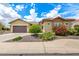 Charming single-Gathering home with lush landscaping, stone accents, and a two-car garage at 20642 N 268Th Dr, Buckeye, AZ 85396
