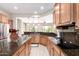 Spacious kitchen featuring wood cabinets, dark granite countertops, and stainless steel appliances at 20642 N 268Th Dr, Buckeye, AZ 85396