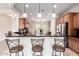 Gourmet kitchen with granite countertops, stainless steel appliances, and a breakfast bar at 20642 N 268Th Dr, Buckeye, AZ 85396