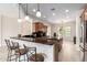 Modern kitchen with a breakfast bar, granite countertops, and stainless steel appliances at 20642 N 268Th Dr, Buckeye, AZ 85396