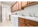 Spacious laundry room with plenty of cabinets, counter space, and a sink at 20642 N 268Th Dr, Buckeye, AZ 85396