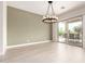 Bright dining area with a stylish chandelier and access to the outdoor patio at 20642 N 268Th Dr, Buckeye, AZ 85396