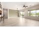 Open-concept living area with kitchen view, a ceiling fan, and a sliding glass door at 20642 N 268Th Dr, Buckeye, AZ 85396