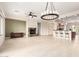 Bright living room with fireplace, chandelier, and open-concept access to the kitchen at 20642 N 268Th Dr, Buckeye, AZ 85396