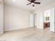 Spacious main bedroom boasts a ceiling fan, light hardwood floors and an ensuite bathroom at 20642 N 268Th Dr, Buckeye, AZ 85396
