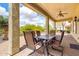Covered patio with a ceiling fan and dining set, perfect for outdoor entertaining at 20642 N 268Th Dr, Buckeye, AZ 85396