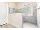 Modern shower features glass partition, mosaic tile floor, and gray tiled walls at 20642 N 268Th Dr, Buckeye, AZ 85396