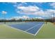 Several tennis courts, fully enclosed and properly lighted, with blue canopies for shade at 20642 N 268Th Dr, Buckeye, AZ 85396