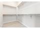Spacious walk-in closet features ample shelving, rod space, and neutral flooring at 20642 N 268Th Dr, Buckeye, AZ 85396