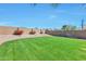 Expansive backyard with well-kept lawn, privacy wall, desert landscaping, and plenty of room for outdoor activities and relaxation at 2312 E Williams Dr, Phoenix, AZ 85024