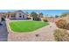 Large backyard with green lawn, desert landscaping, privacy wall, and space for outdoor activities and entertaining at 2312 E Williams Dr, Phoenix, AZ 85024