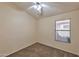 Neutral bedroom featuring carpet, ceiling fan, and window for natural lighting at 2312 E Williams Dr, Phoenix, AZ 85024