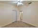 Bedroom with carpet, a ceiling fan, closet, and doorway leading to the en suite bathroom at 2312 E Williams Dr, Phoenix, AZ 85024