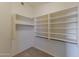 Spacious walk-in closet with built-in shelving and ample storage space for organizing clothes and accessories at 2312 E Williams Dr, Phoenix, AZ 85024