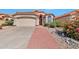 Charming home featuring a well-manicured front yard, a brick walkway, and a two-car garage at 2312 E Williams Dr, Phoenix, AZ 85024