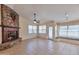 Inviting living space with a cozy stone fireplace, tile flooring, and abundant natural light at 2312 E Williams Dr, Phoenix, AZ 85024