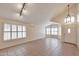 Bright living room featuring tile floors, plantation shutters, track lighting, and vaulted ceilings at 2312 E Williams Dr, Phoenix, AZ 85024