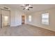 Spacious bedroom with large closet, three windows, and neutral plush carpet at 2312 E Williams Dr, Phoenix, AZ 85024