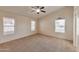 Spacious main bedroom with plush carpet, neutral walls, and three bright windows at 2312 E Williams Dr, Phoenix, AZ 85024