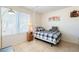 Inviting bedroom featuring a twin size bed, lamp and natural light at 3107 W Tuckey Ln, Phoenix, AZ 85017