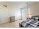 Comfortable bedroom featuring a twin size bed, lamp and natural light at 3107 W Tuckey Ln, Phoenix, AZ 85017