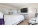 Relaxing bedroom featuring a full size bed, television, work space and neutral walls at 3107 W Tuckey Ln, Phoenix, AZ 85017