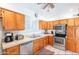 Kitchen with wooden cabinets, stainless steel appliances, and tile countertops at 3107 W Tuckey Ln, Phoenix, AZ 85017