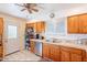 Kitchen features wooden cabinets, a stainless steel dishwasher, and a door to the outside at 3107 W Tuckey Ln, Phoenix, AZ 85017