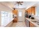 Kitchen features wooden cabinets, tile countertops, and a door to the outside at 3107 W Tuckey Ln, Phoenix, AZ 85017