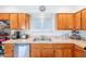 Kitchen featuring wooden cabinets, stainless steel appliances, and tile countertops at 3107 W Tuckey Ln, Phoenix, AZ 85017