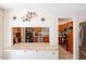 Pass through view of the kitchen with wooden cabinets and tile countertops at 3107 W Tuckey Ln, Phoenix, AZ 85017
