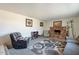 Spacious living room with comfortable seating, a brick fireplace and carpet at 3107 W Tuckey Ln, Phoenix, AZ 85017
